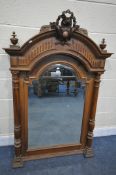 A 20TH CENTURY FRENCH WALNUT OVERMANTEL MIRROR, with a foliate and ribbon pediment, and two finials,
