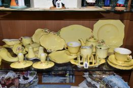 A LARGE QUANTITY OF ROYAL WINTON YELLOW 'PETUNIA' PATTERN TABLEWARE, comprising a square cake plate,