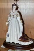 A ROYAL WORCESTER 'QUEEN ELIZABETH II' FIGURINE, depicting the late Queen in her coronation robes, a