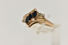 A YELLOW METAL GEM SET RING, designed as a row of three marquise cut deep blue sapphires