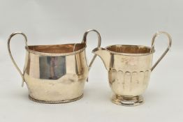 A LATE VICTORIAN SILVER TWIN HANDLED SUGAR BOWL OF OVAL FORM AND A GEORGE V SILVER MILK JUG, the