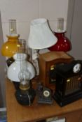 A GROUP OF LAMPS AND CLOCKS, to include four Aladdin oil lamps of which three have opaque glass
