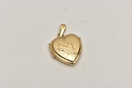 A HEART SHAPED LOCKET, engraved with foliate detail to the front, suspension loop stamped 750,
