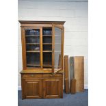 AN EARLY 20TH CENTURY OAK GLAZED TWO DOOR BOOKCASE, with two drawers and fielded panel doors,