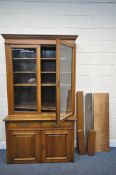 AN EARLY 20TH CENTURY OAK GLAZED TWO DOOR BOOKCASE, with two drawers and fielded panel doors,
