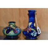 TWO MOORCROFT POTTERY VASES DECORATED IN THE ORCHID AND SPRING FLOWERS PATTERN, comprising squat