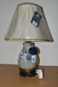 A MODERN MOORCROFT POTTERY TABLE LAMP WITH SHADE, the lamp decorated with waterlily style flowers on