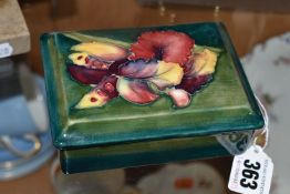 A MOORCROFT POTTERY RECTANGULAR TRINKET BOX AND COVER, green / blue ground, decorated with an orchid