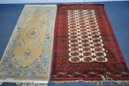 A WOOLLEN RED AND CREAM TEKKE RUG, 197cm x 127cm, along with a rectangular Chinese rug, 195cm x 93cm