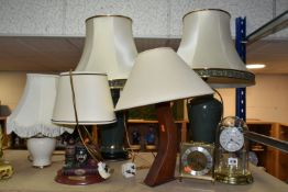 A GROUP OF LAMPS AND CLOCKS, to include a pair of green ceramic table lamps with cream shades,