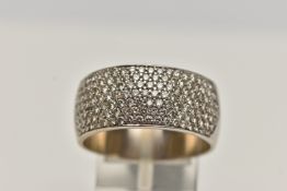 A DIAMOND SET WIDE BAND RING, set with seven rows of brilliant cut diamonds to the front half