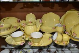 A QUANTITY OF ROYAL WINTON YELLOW 'PETUNIA' DESIGN TEA WARE, comprising two tennis sets (one cup