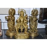 THREE GILT METAL RELIGIOUS HINDU FIGURES, comprising Lord Hanuman, height 30cm, and two figures of