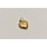 A YELLOW METAL HEART PENDANT, a hollow heart pendant with embossed detail of two people kissing,