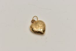 A YELLOW METAL HEART PENDANT, a hollow heart pendant with embossed detail of two people kissing,