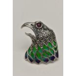 A WHITE METAL PLIQUE A JOUR BROOCH, in the form of an eagle head, set with a ruby cabcohon eye,