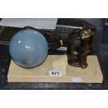 A FRENCH ART DECO TABLE LAMP, featuring a seated cat figure and a blue glass globe shade on a