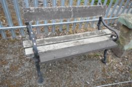 A CAST IRON SERPENT AND TWIG GARDEN BENCH, with wooden slats, length 127cm x depth 57cm x height