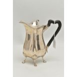 AN EDWARDIAN SILVER HOT WATER JUG OF QUATREFOIL FORM, ebonised handle, on four cabriole legs with