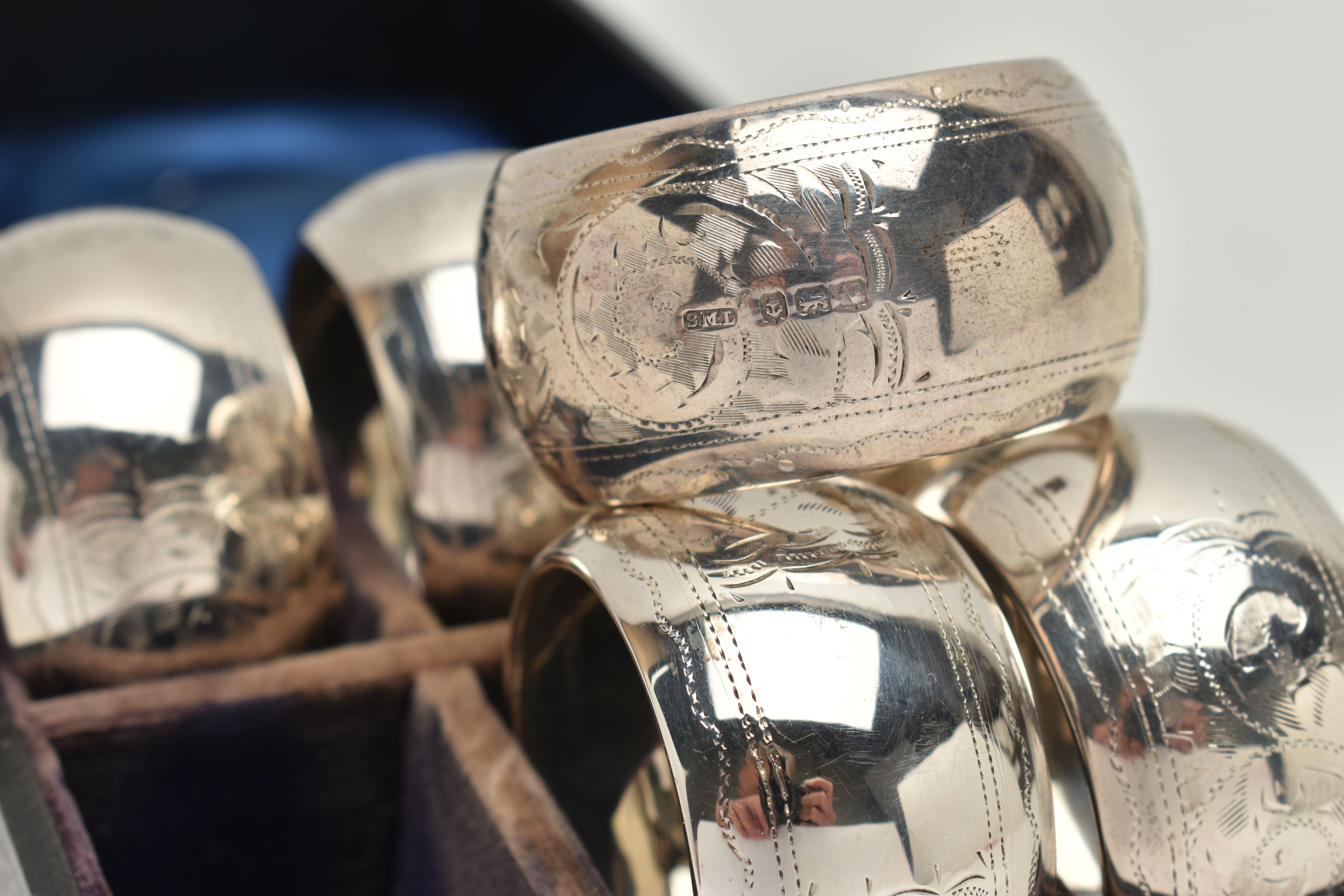 A CASED SET OF SIX GEORGE V CIRCULAR SILVER NAPKIN RINGS, foliate engraved decoration, vacant - Image 2 of 3