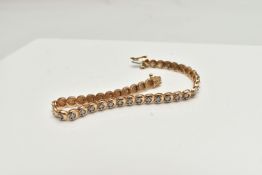 A 9CT GOLD DIAMOND LINE BRACELET, designed as a series of circular links each set with a small round