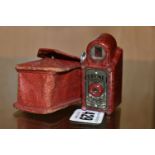 A RED BAKELITE CORONET MIDGET POCKET CAMERA, made by the Coronet Camera Co. Birmingham, with