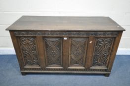 A GEORGIAN CARVED OAK PANELLED COFFER, width 141cm x depth 56cm x height 79cm (condition report:-
