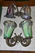 TWO WALL LIGHT FITTINGS WITH IRIDESCENT GLASS LAMP SHADES, the brass light fittings of scrolling,