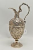 A SILVER PLATED EWER, embossed decoration, on a round base with scroll handle, approximate height