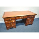 A 20TH CENTURY MAHOGANY PEDESTAL DESK, with a later hardwood writing surface, and nine drawers, on