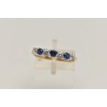 A 14CT GOLD GEM SET RING, three circular cut sapphires and four circular cut cubic zirconia, prong