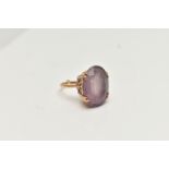 A 9CT GOLD AMETHYST DRESS RING, large oval cut pale amethyst, four claw set in an openwork scroll