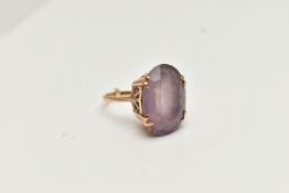 A 9CT GOLD AMETHYST DRESS RING, large oval cut pale amethyst, four claw set in an openwork scroll