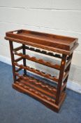 A HARDWOOD WINE RACK with a removable tray, and twenty-four wine holders, width 77cm x depth 31cm
