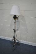 AN ARTS AND CRAFTS WROUGHT IRON, BRASS AND COPPER CONVERTED OIL LAMP, fitted with an electrical