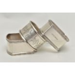 A PAIR OF ELIZABETH II RECTANGULAR SILVER NAPKIN RINGS AND A CIRCULAR NAPKIN RING, the pair with