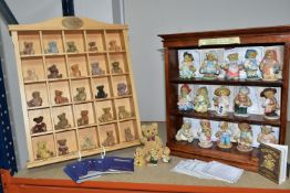 A LARGE COLLECTION OF BEAR FIGURINES, comprising a dark wood cabinet, height 40cmx 39cm containing