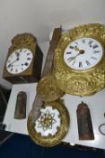 TWO COMPTOISE CLOCKS, the larger clock has a pressed gilt metal with white enamel pendulum and