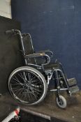 A KARMA DOVE FOLDING WHEELCHAIR with two footrests