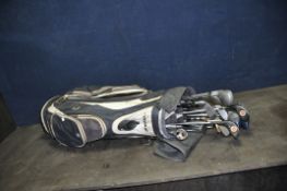 A TAYLOR MADE GOLF BAG CONTAINING ELEVEN DRIVERS by Dunlop, Gowers Brown, Fibreflex, etc, two putter