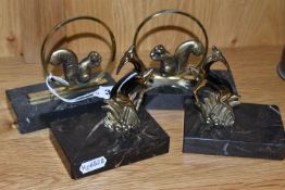 TWO PAIRS OF ART DECO BOOKENDS, comprising a near pair in the form of brass squirrels seated in