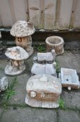 A SELECTION OF WEATHERED COMPOSITE GARDEN ITEMS, to include two fairy mushroom houses, small tree