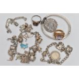 A SELECTION OF SILVER AND WHITE METAL JEWELLERY, to include three charm bracelets, a hinged