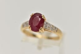 AN 18CT GOLD RUBY AND DIAMOND RING, set with an oval cut ruby, four claw set, flanked with single