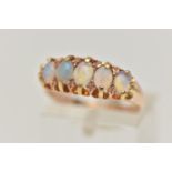 A LATE VICTORIAN 15CT GOLD OPAL RING, designed as a row of five oval cut opals, each claw set to a
