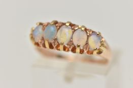 A LATE VICTORIAN 15CT GOLD OPAL RING, designed as a row of five oval cut opals, each claw set to a