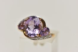 AN AMETHYST AND DIAMOND RING, designed as an oval amethyst flanked by pear shape amethysts to the