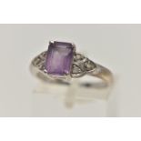 A 9CT WHITE GOLD AMETHYST AND SPINEL RING, set with a rectangular cut amethyst, four claw set,