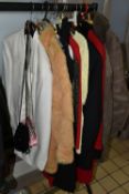A GROUP OF SIXTEEN PIECES OF VINTAGE CLOTHING, comprising two light brown real sheepskin jackets, an