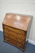 A GEORGIAN OAK BUREAU, the fall front section enclosing a fitted interior, over four drawers, on